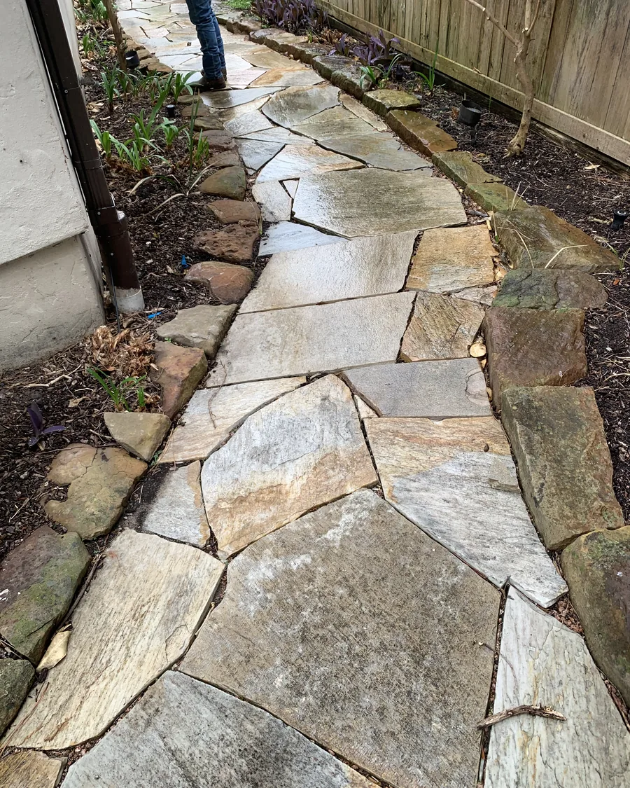 Irregular flagstone path set tight with stone edging