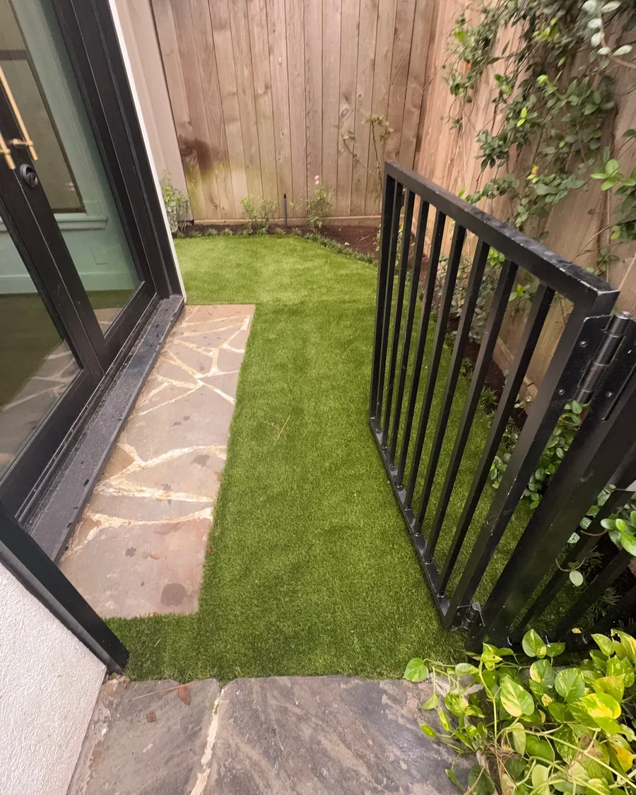 Turf laid up to a flagstone landing outside a back door