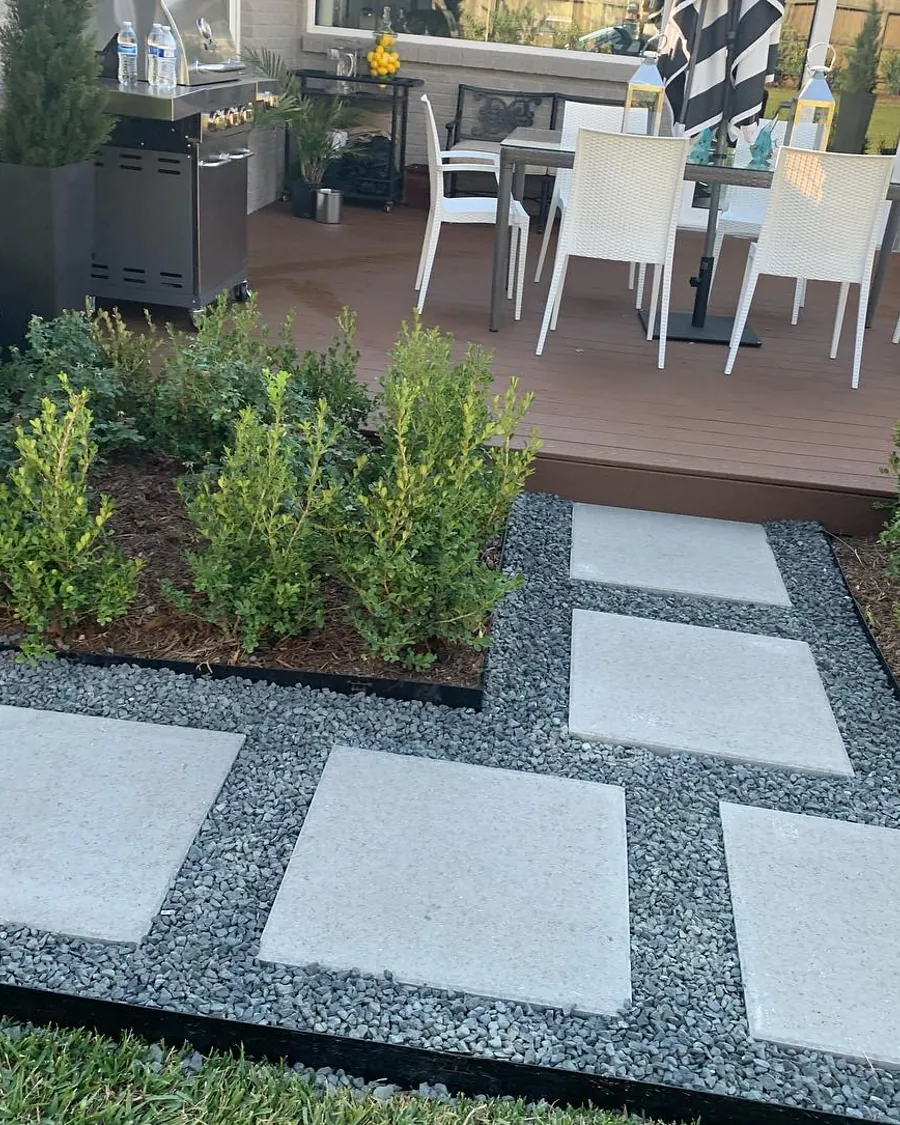 Modern gray paver stepping path set in river rock