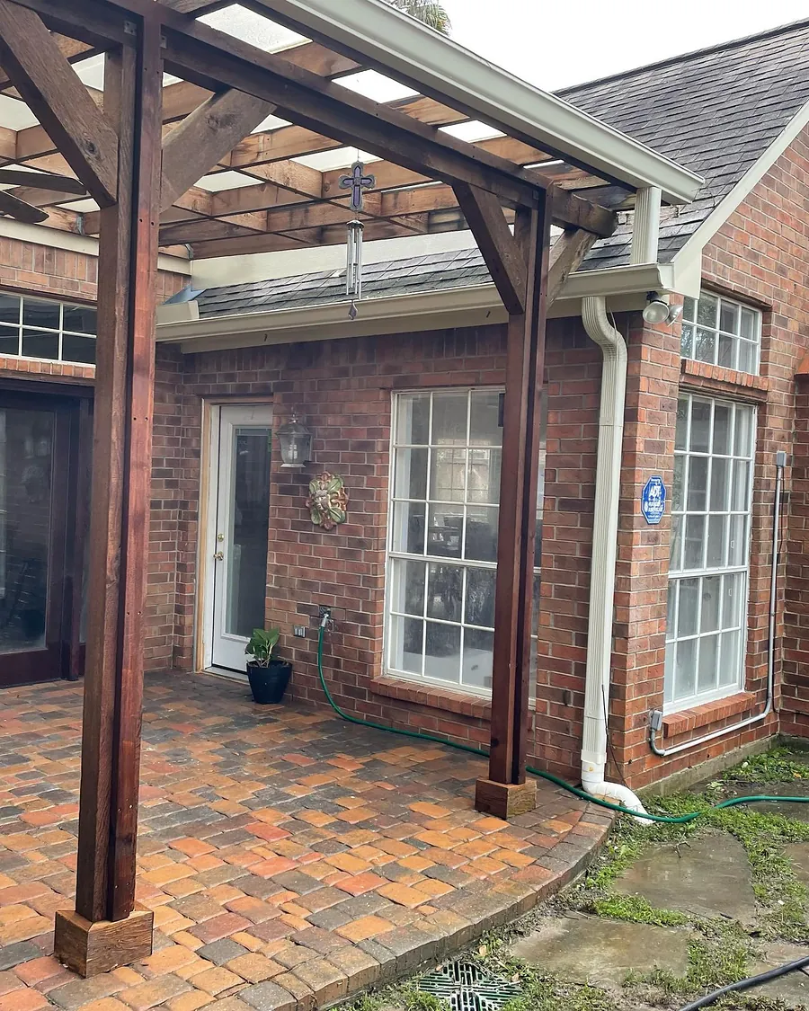 Brick paver patio under a wood pergola