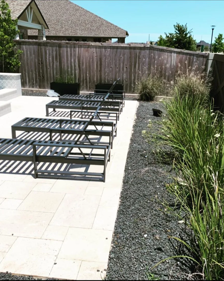 Pool deck with pavers, loungers and an ornamental grass border